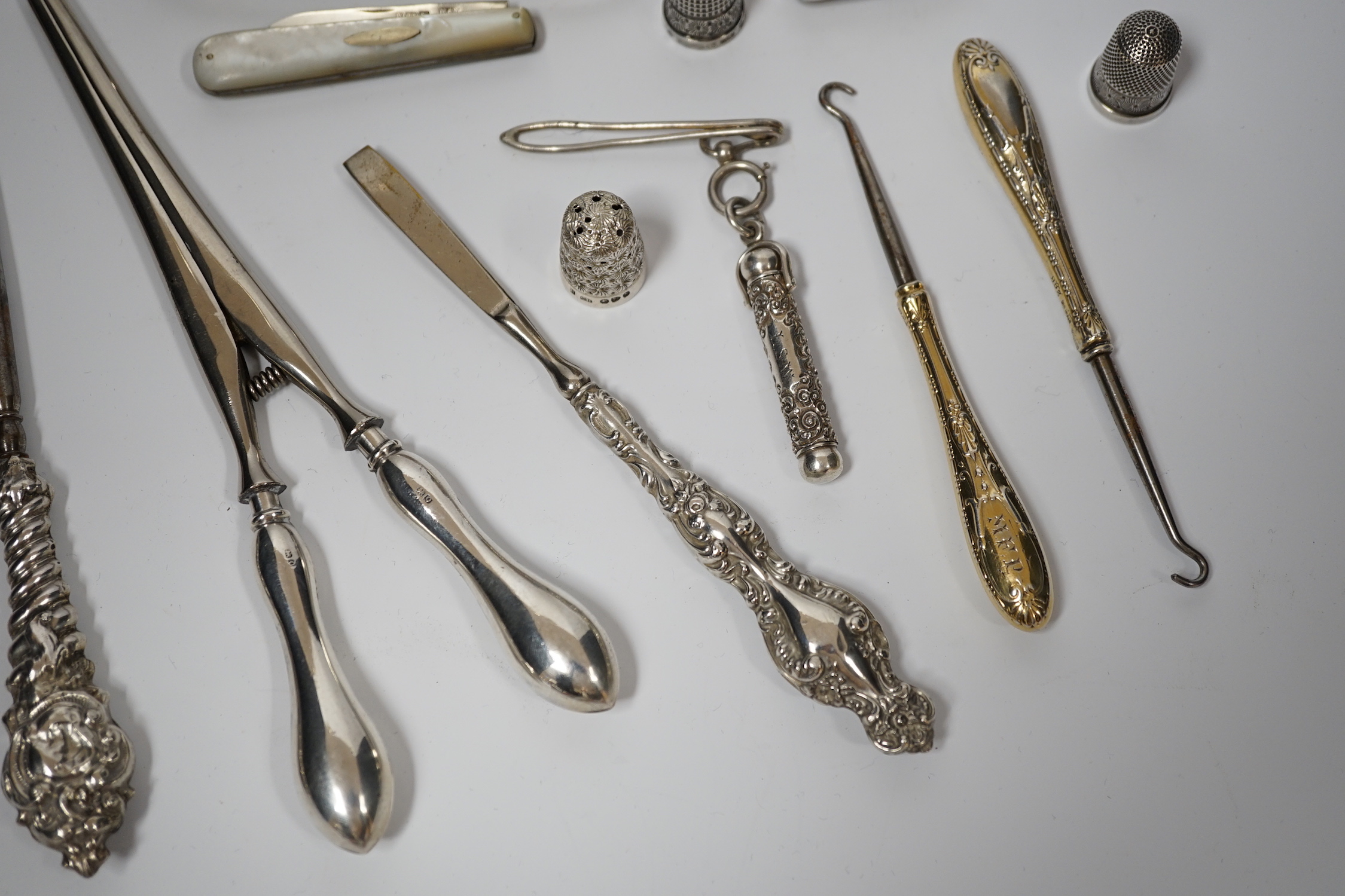 A George V silver cigarette case, Adie Bros. Birmingham, 1929, two silver and two sterling mounted button hooks and seven other items including propelling pencil in case, fruit knife and Italian 800 standard scent flask.